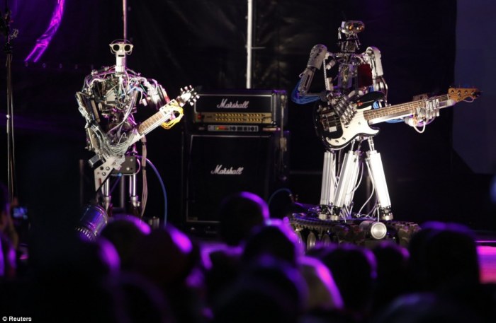 Musician rock out with robot bandmates