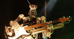 Musician rock out with robot bandmates