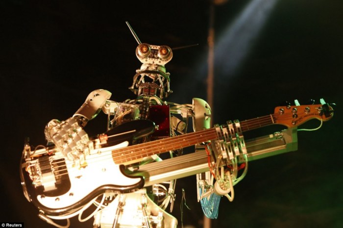 Musician rock out with robot bandmates